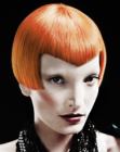 Mid-ear bob with pointed bangs for lava red hair
