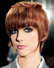 Razor-cut pixie hairstyle with tapered layers and point cut bangs