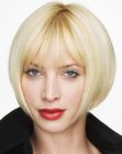 Classy blonde bob with an angled cutting line and light bangs