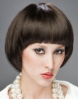 Sleek hair cut in a bowl shape around the face