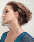 Voluminous short hairstyle with the hair swept to the back
