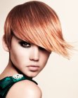 Short reddish blonde hair with tear drop shape bangs