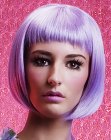 Purple chin length bob with very short textured bangs