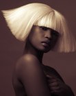 Beveled bob with horizontal bangs for platinum blonde hair