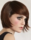 Short bob with feathered contours and striking bangs