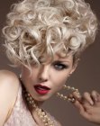 Short blonde hair with tumbling 1950s curls