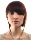 Smooth bob haircut with angled bangs and elongated lines