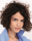 Voluminous chin length bob with curls of various sizes