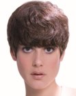 Pixie cut with a rounded silhouette and wavy bangs