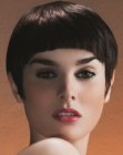 Short retro hairstyle with sideburns and arched bangs
