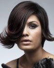 Short hairstyle with a deep side part and an upward flip