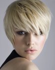 Blonde head-hugging pixie cut with lash length bangs