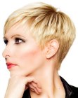 Blonde pixie cut with layers and a very short nape