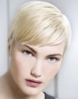 Sleek blonde pixie cut with diagonal bangs