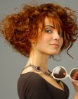 Short copper color hair with curls and a long neckline