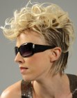 Short hairstyle with Mohawk shaped curls and two tone coloring