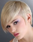 Blonde hair in a short graduated cut with sideburns