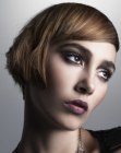Modern short haircut with pointed sides and diagonal bangs