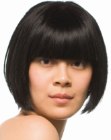 Classic chin length bob with thick bangs and curved sides