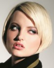 Blonde hair cut in a sleek A-line bob with Mod elements