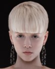 Blonde hair with buzzed sides and back and long bangs