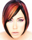 Short bob with swooping bangs and accent hair colors