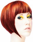 Short layered bob with bangs and an elongated sideburn