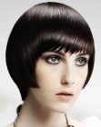 Short haircut with point cut bangs and sleek styling