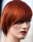 Haircut with diagonal styling for bright red hair