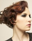Wedge shape hairstyle with a short nape and curls