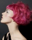 Short pink hair with large curls and straight bangs