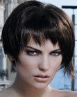 Short asymmetrical haircut with irregular edges and deconstructed bangs