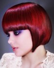 Red hair cut to a chin length bob with a round fall