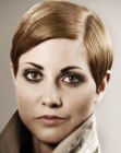 Short women's haircut with a sleek pomade finish