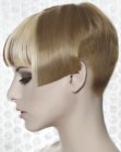 Very short haircut with a buzzed nape for women