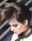 Short hair with long bangs styled into a high arch
