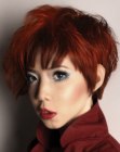 Asian hair colored red and cut into a choppy short hairstyle
