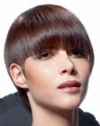 Short avant-garde haircut for shiny brown hair