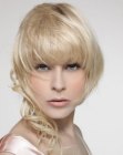 Rounded bob with deep bangs and long curled tendrils