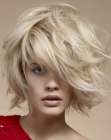 Blonde bob with thick layers and styling for a wind swept look
