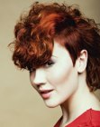 Short haircut with a long back side and voluminous curls