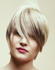 Short haircut with angled styling and a feather of hair