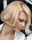Short blonde bob with an overlapping partition and feathery bangs