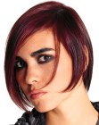 Cheek-length haircut with tapered ends and sleek styling