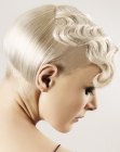 Ear-lobe length vintage hairstyle with fingerwaves and a clipper cut neck