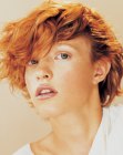 Short red hair with full bangs and deconstructed curls