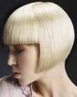 Short blonde A-line bob that follows the contour of the head