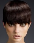 Sleek cap shape haircut with the hair cut at eye-level