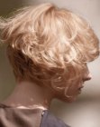 Short angled bob with a graduated neckline and curls