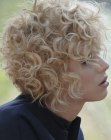 Short blonde hair with a shorter back and light curls